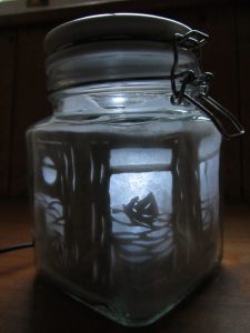 glass kilner jar with moonlight image of boat sailing on the waves