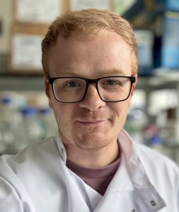 Dr Oliver Mann in a lab coat