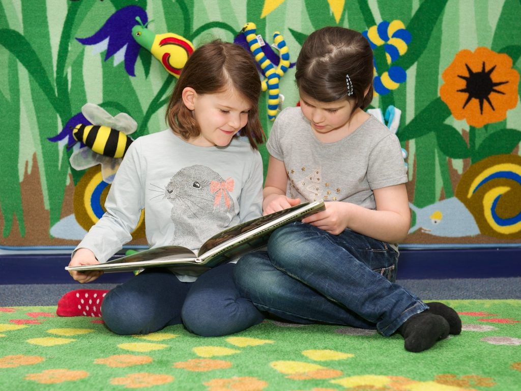 Two children enjoying a book together