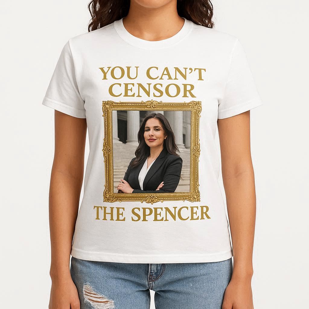 product photo of a white t-shirt that says YOU CAN'T CENSOR at the top, and THE SPENCER at the bottom in gold writing. in the middle is a professional law firm portrait photo of a glamorous, self-satisfied lawyer with long dark hair posing outside a court. the picture has an ornate gilt border. the t-shirt is modelled by a woman in ripped jeans. the background is studio white.