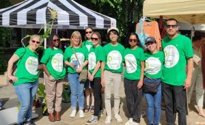 Group of 9 persons wearing a green t-shirt for Fascination of Plants Day in Lancaster Market