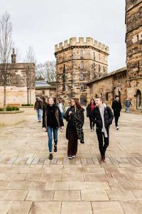 Group of people walking in the castle grounds