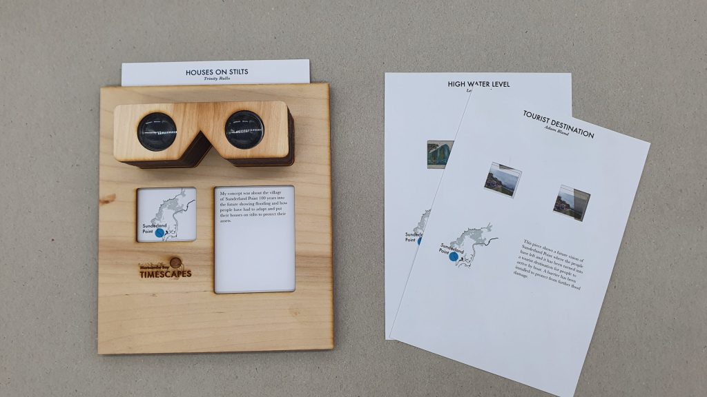 plywood stereoscope with stereographic cards next to it on a grey background