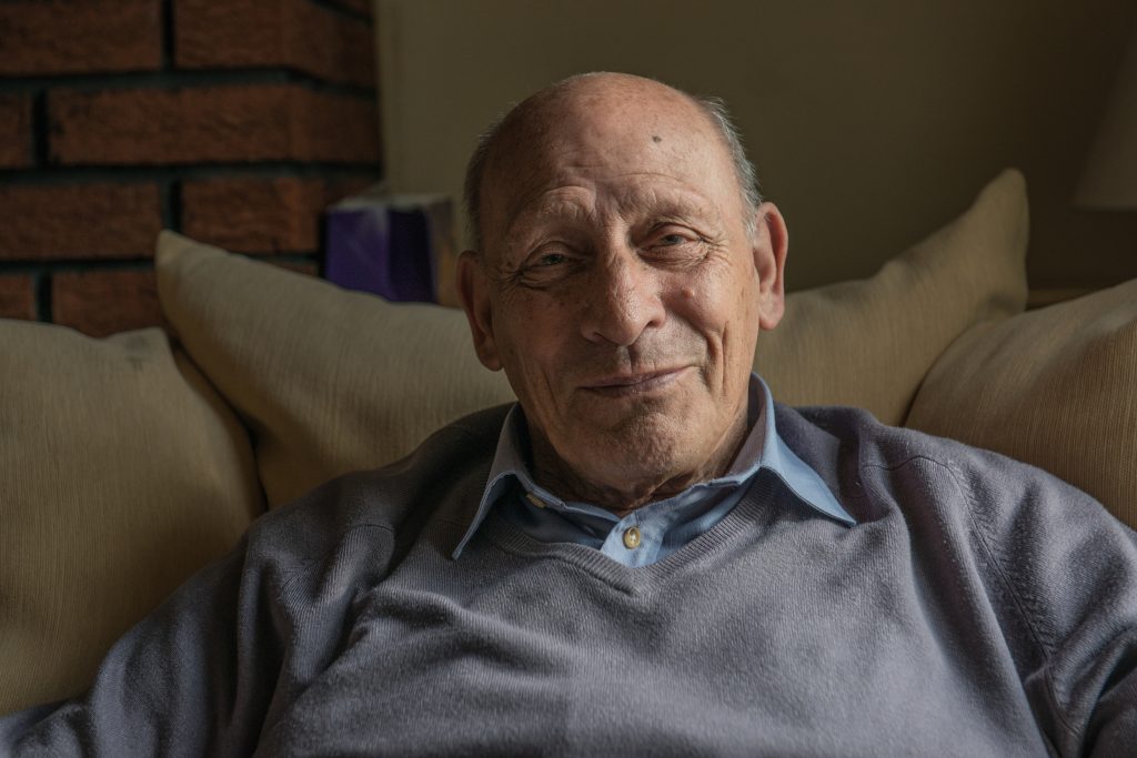 A close up shot of a man who smiles at the camera.